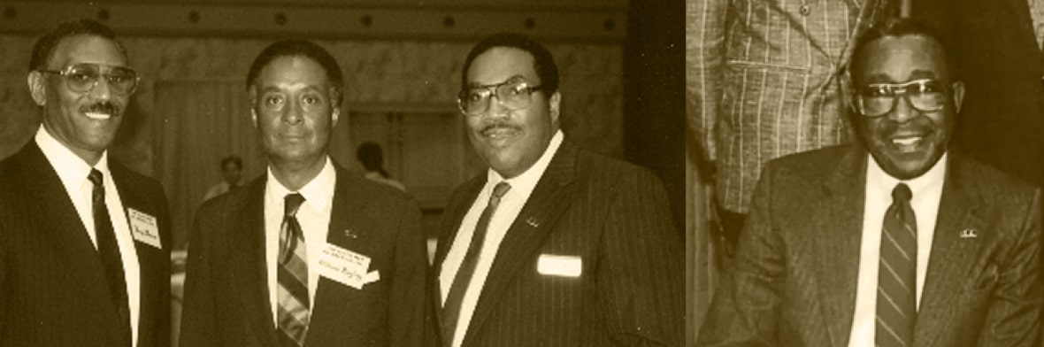 Sepia group photo of four men in suits standing together